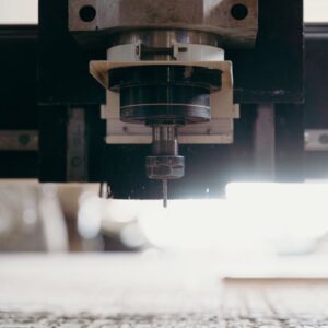 Detailed view of a CNC machine carving material, showcasing industrial precision.