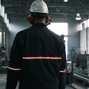 A man in a factory wearing a hard hat